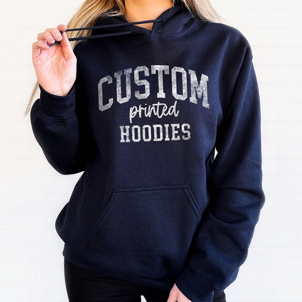 a young woman wearing a custom printed hoodie in navy
