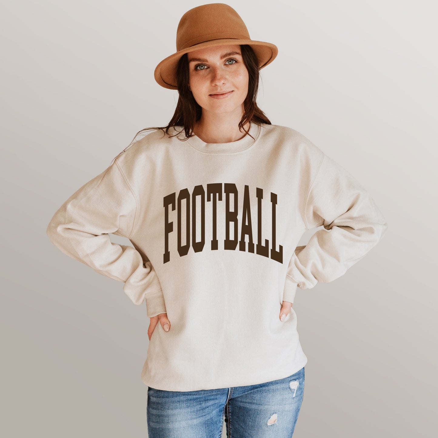 a young woman wearing a football sweatshirt in Sand