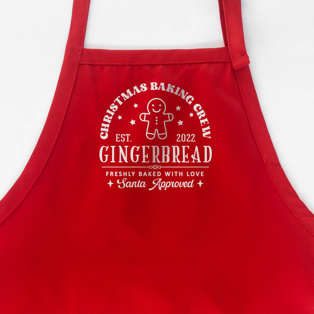 
                  
                    a Christmas baking crew apron in red
                  
                
