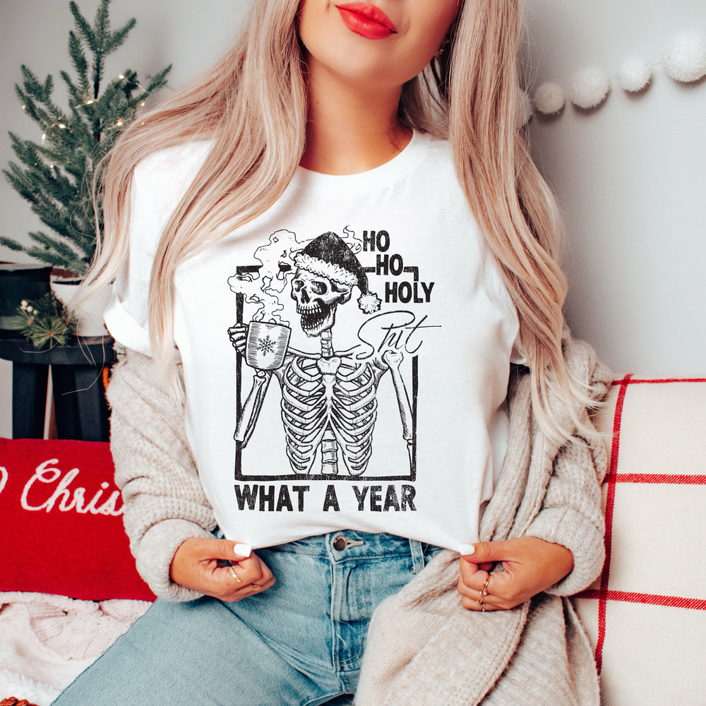 a pretty woman in a Christmas scene wearing a funny skeleton shirt 