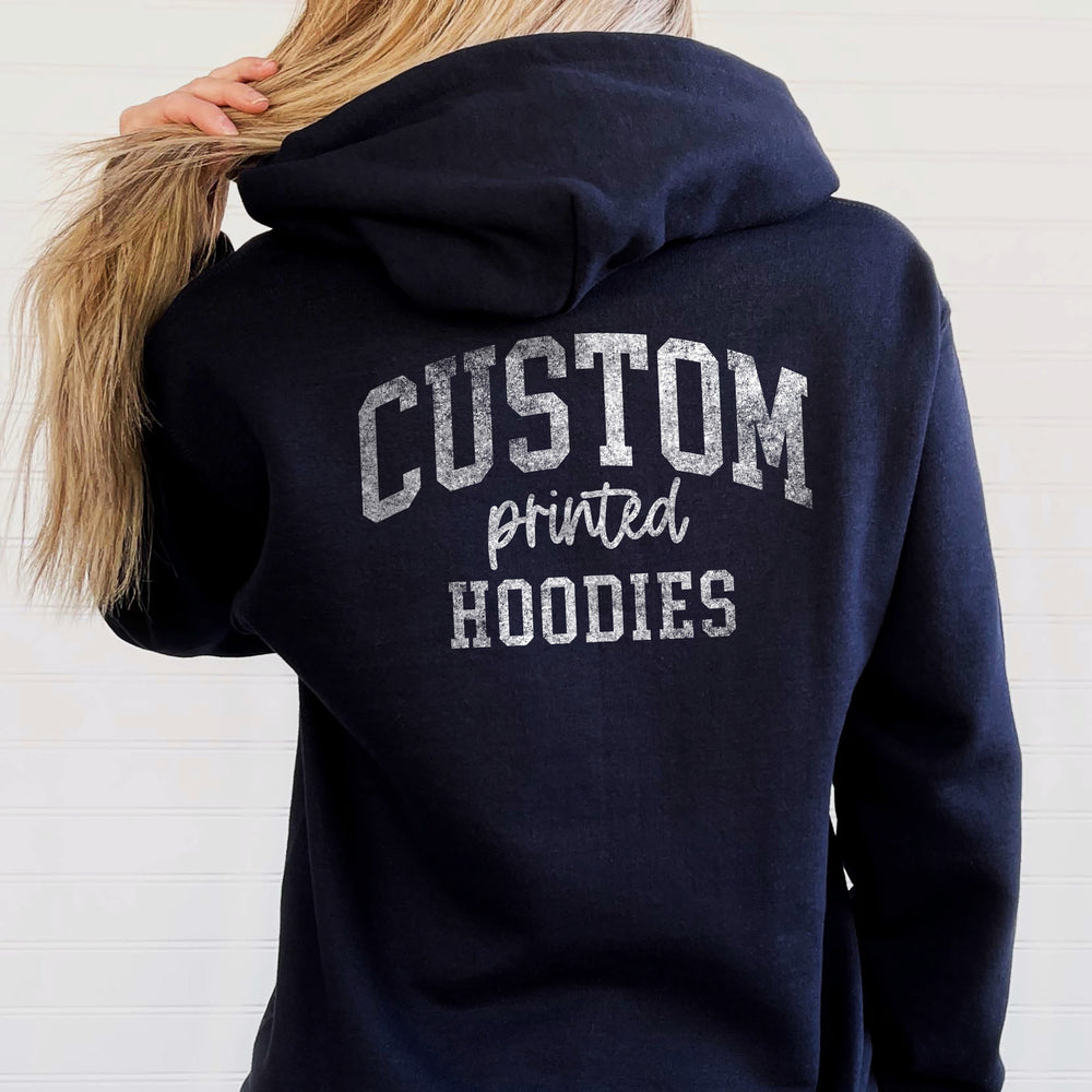 a back shot of a young woman wearing a custom printed hoodie in navy