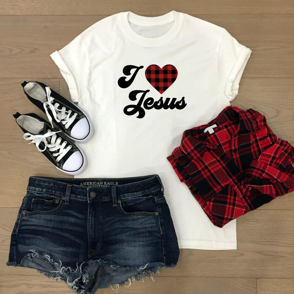 
                  
                    I Heart Jesus svg printed on a white tee, layed out with shorts, plaid flannel shirt and converse shoes
                  
                