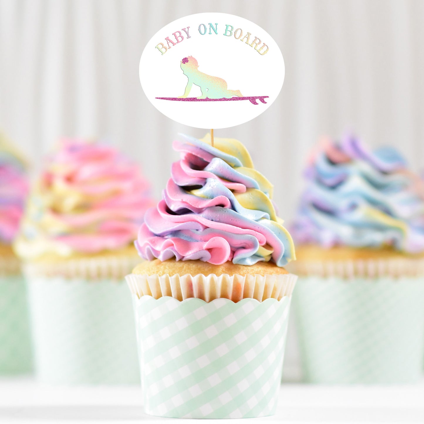 
                  
                    pastel swirl cupcakes with a Baby On Board - Surf Girl - SVG topper printed in holographic and glitter HTV
                  
                