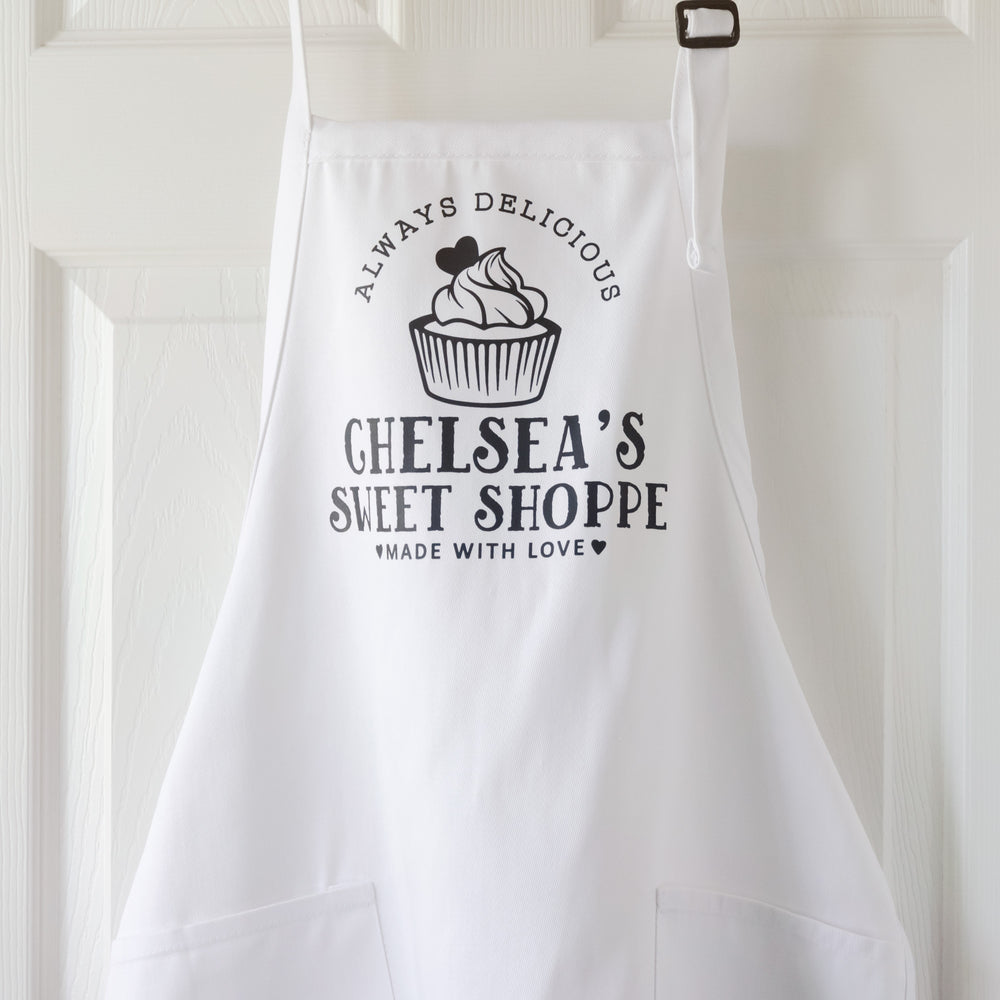 a personalized cupcake baking apron in white