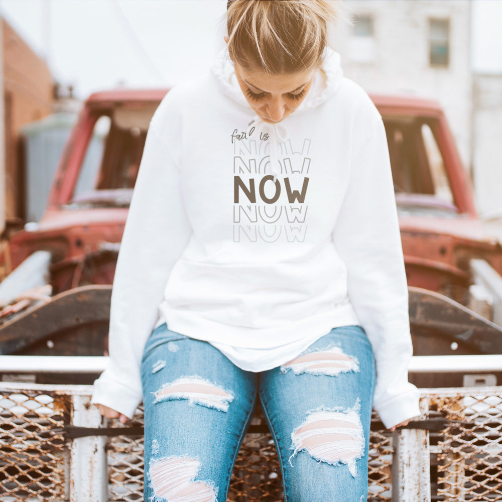 
                  
                    a young woman sitting on a broken down car, wearing a hoodie printed with Faith Is Now - SVG
                  
                