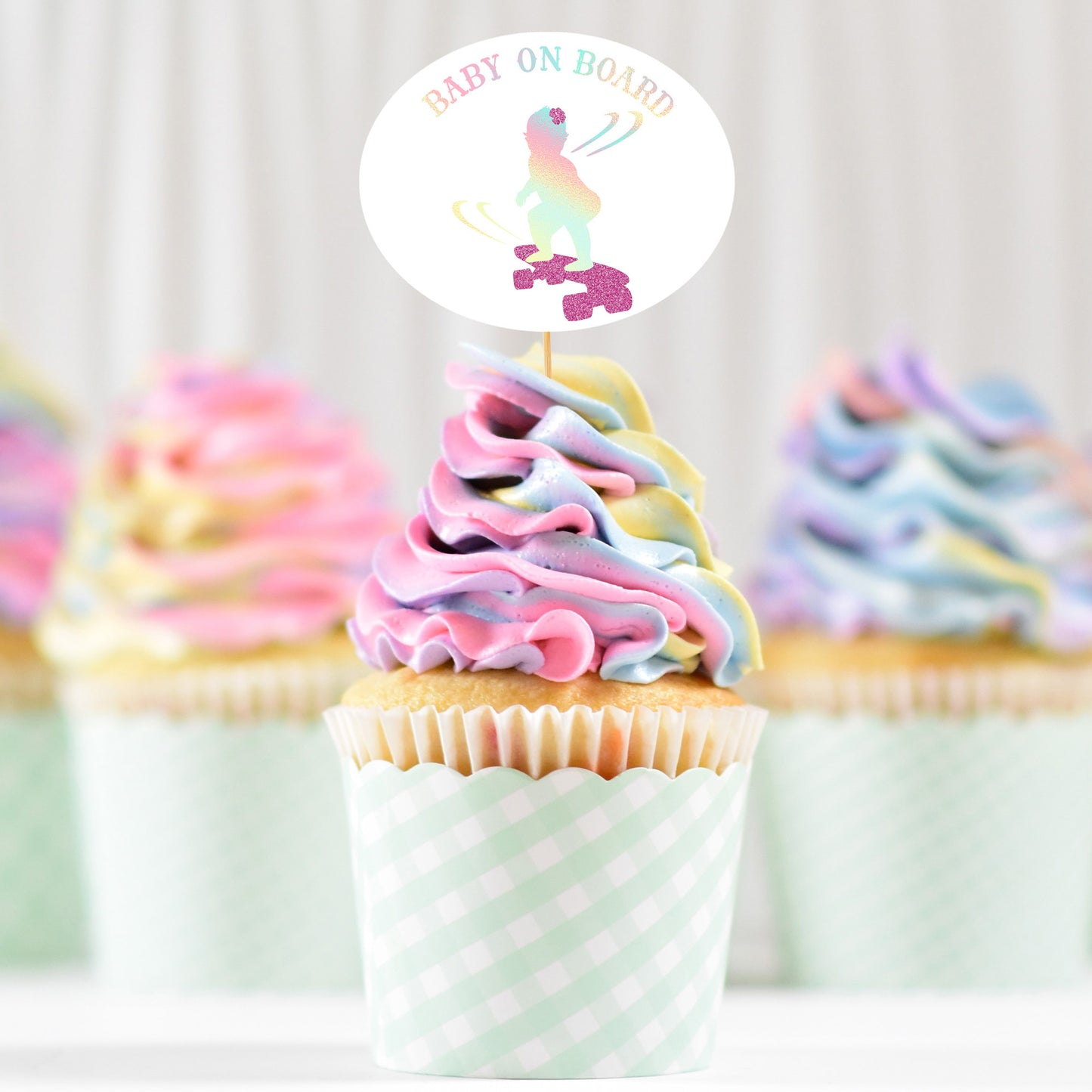 
                  
                    pastel swirl cupcakes with a Baby On Board - Skateboarding Girl SVG topper, printed in holographic and glitter
                  
                