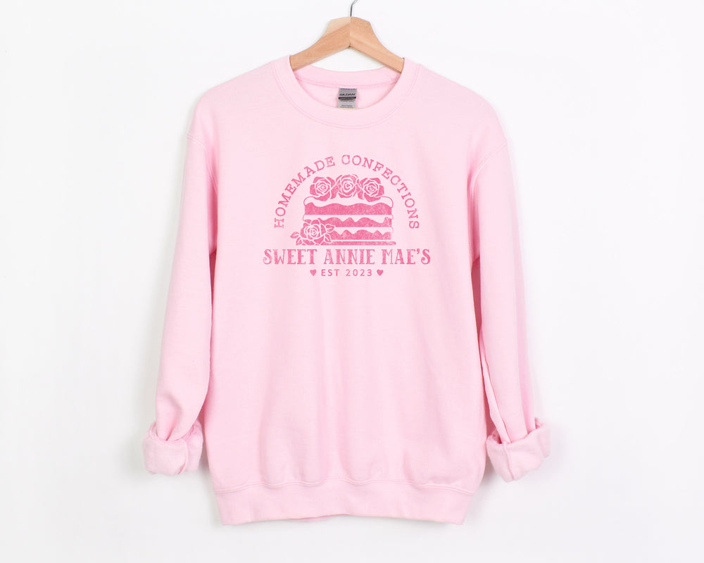 
                  
                    a personalized cake baker sweatshirt in light pink
                  
                