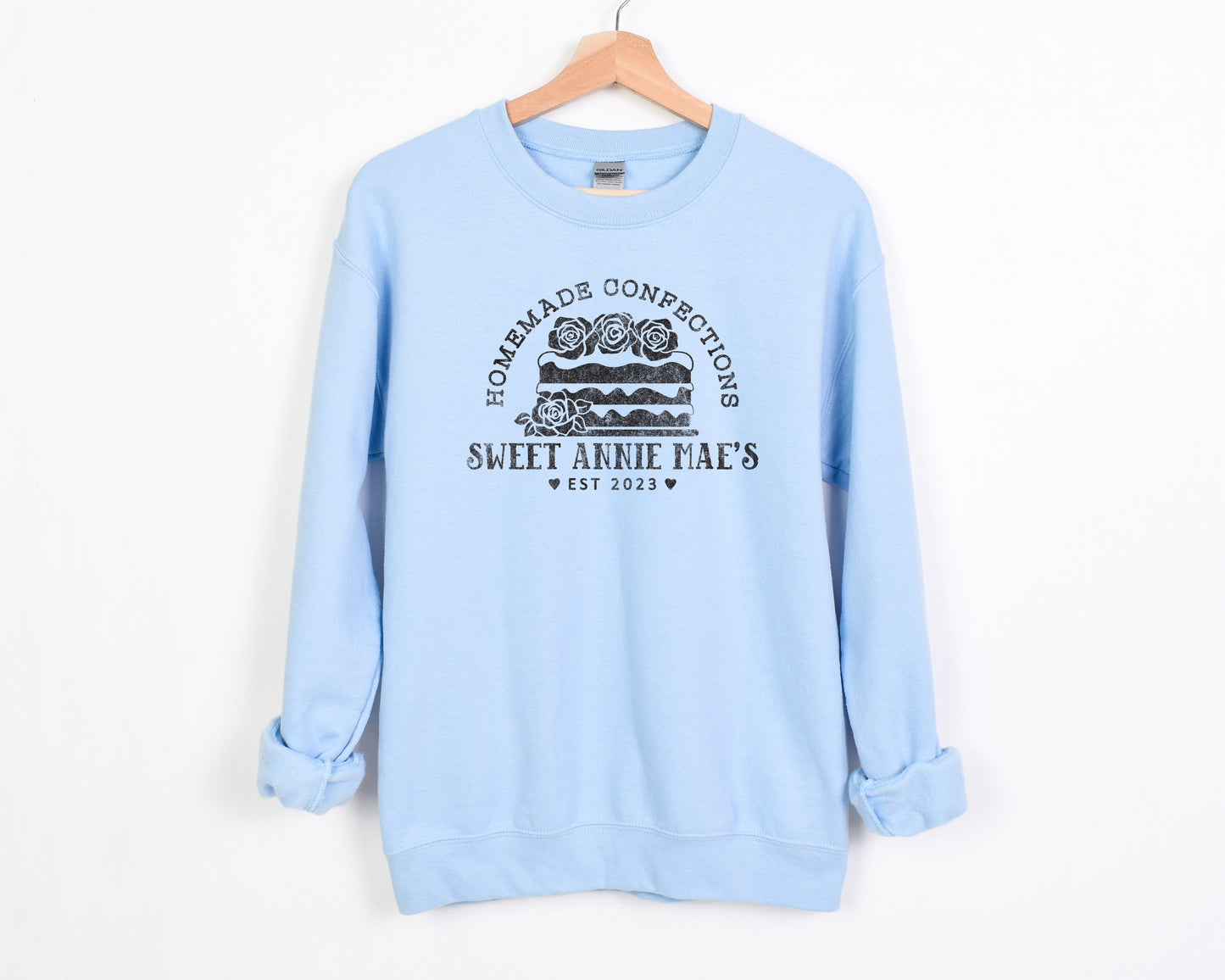 
                  
                    a personalized cake baker sweatshirt in light blue
                  
                