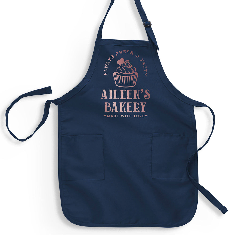 a navy apron printed with rose gold metallic reading 