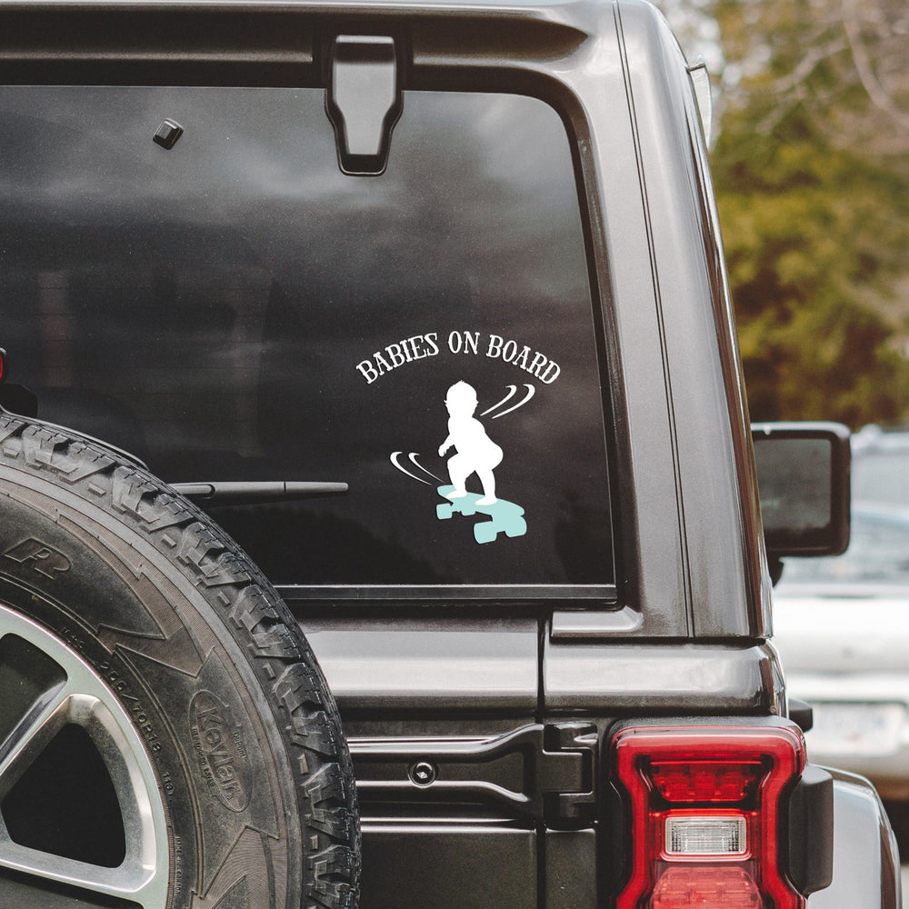 babies on board, skateboarding svg, cut as a car decal, shown on the rear window of a black jeep
