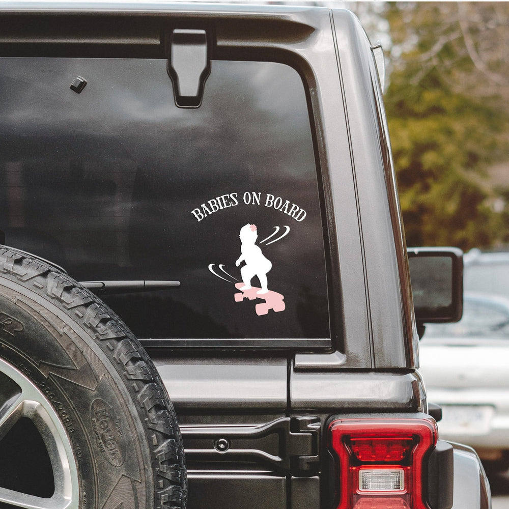 
                  
                    babies on board, skateboarding girl svg, cut as a car decal, shown on the rear window of a black jeep
                  
                