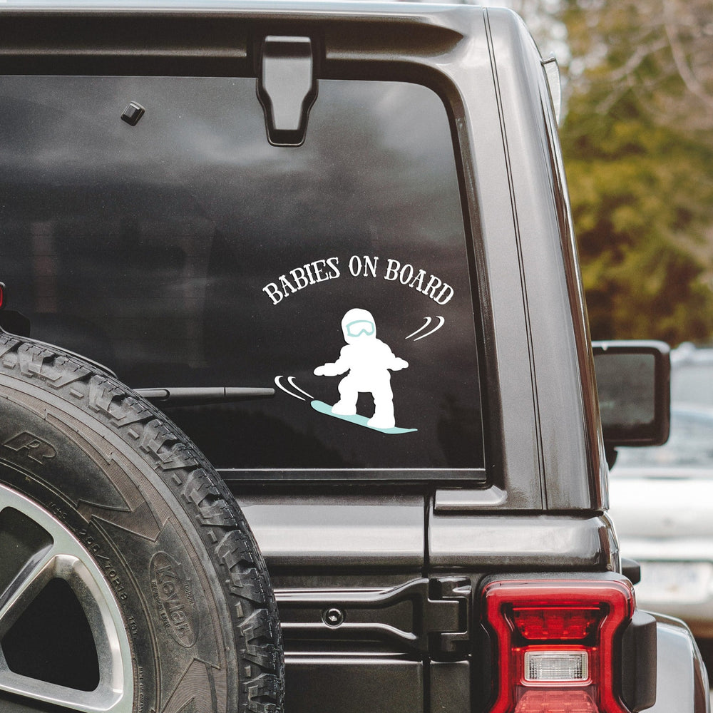 
                  
                    babies on board, snowboarding svg, cut as a car decal, shown on the rear window of a black jeep
                  
                