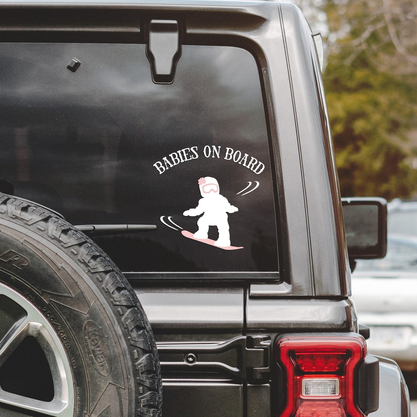 
                  
                    babies on board, snowboarding girl svg, cut as a car decal, shown on the rear window of a black jeep
                  
                