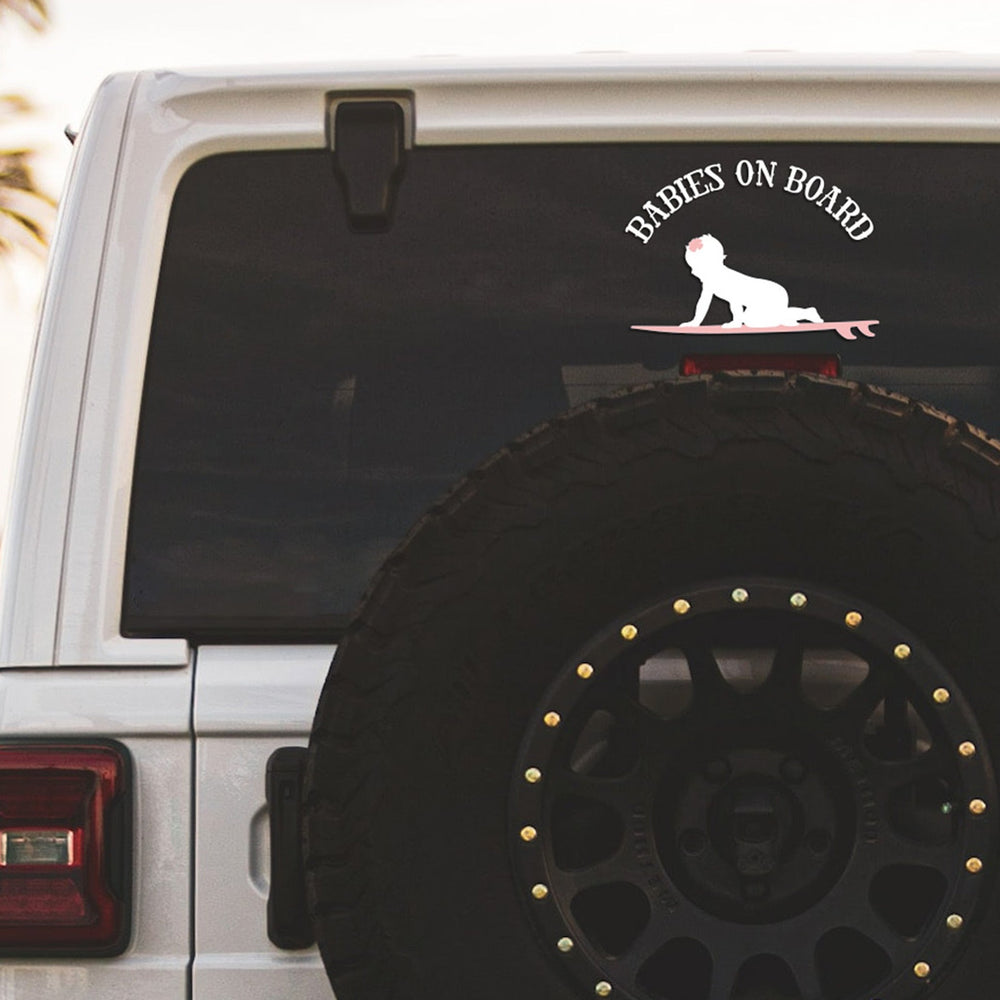 
                  
                    babies on board, surfboarding girl svg, cut as a car decal, shown on the rear window of a black jeep
                  
                