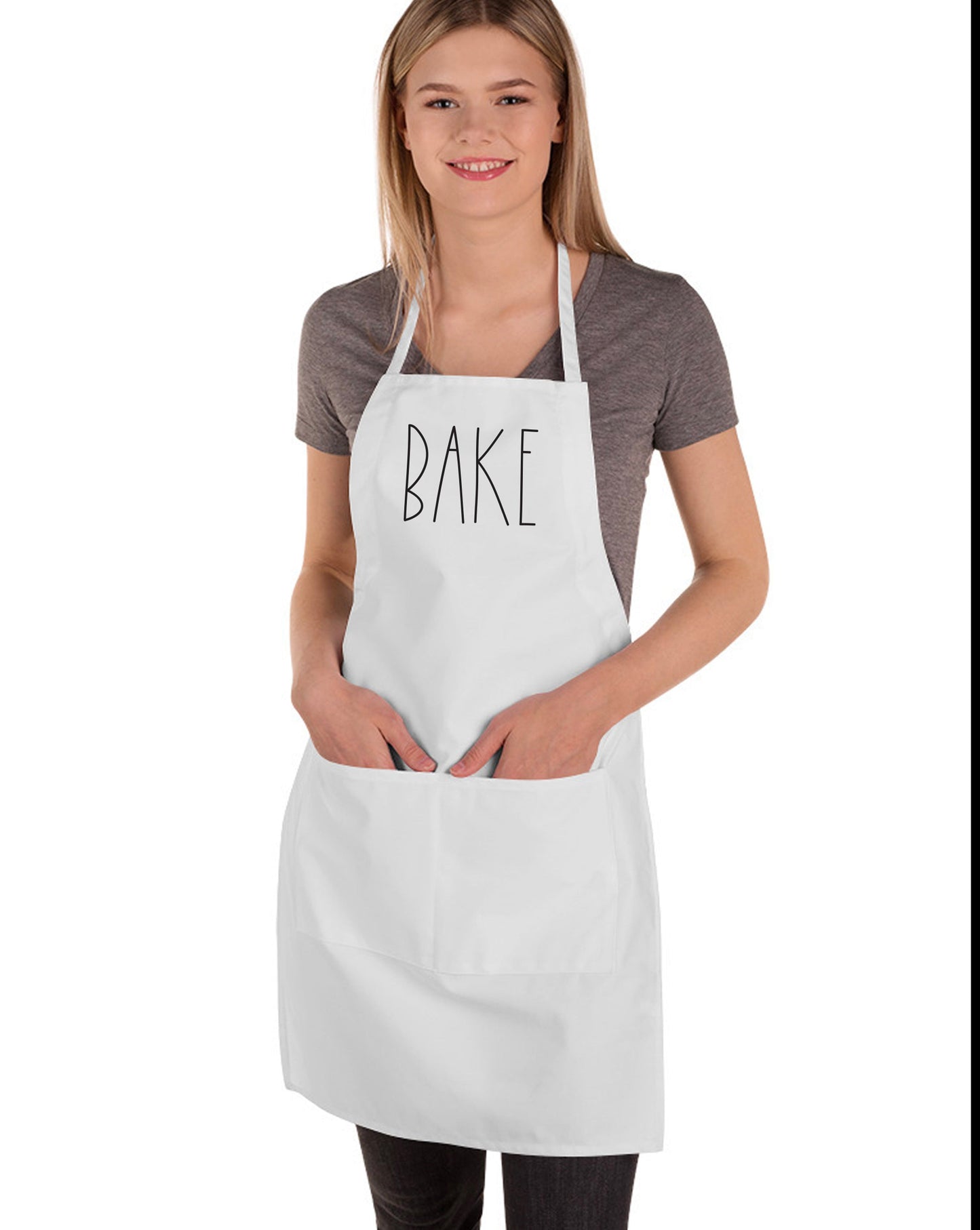 
                  
                    a young woman wearing a bake apron by peculiar people designs
                  
                