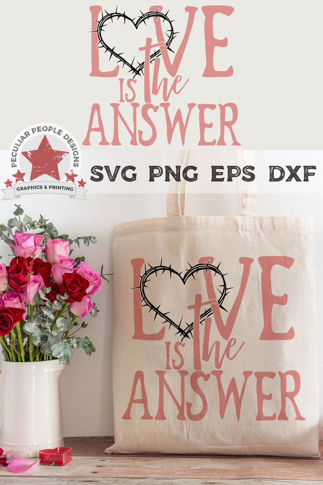 
                  
                    love is the answer svg printed on a tote bag set next to a bouquet of roses
                  
                