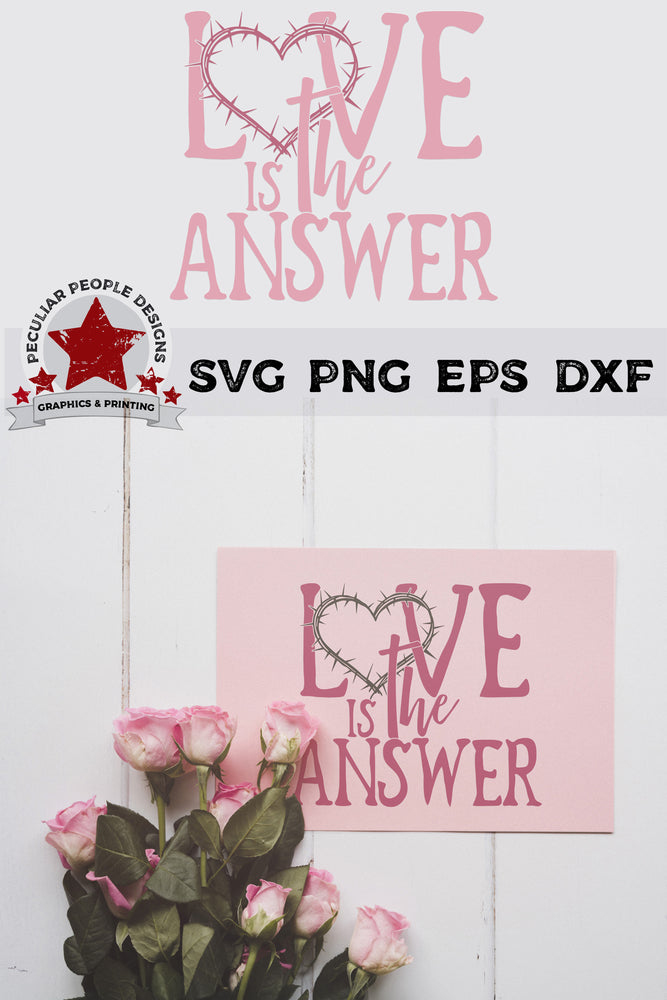 
                  
                    love is the answer svg embossed on a greetig card, laying under a bunch of pink roses
                  
                