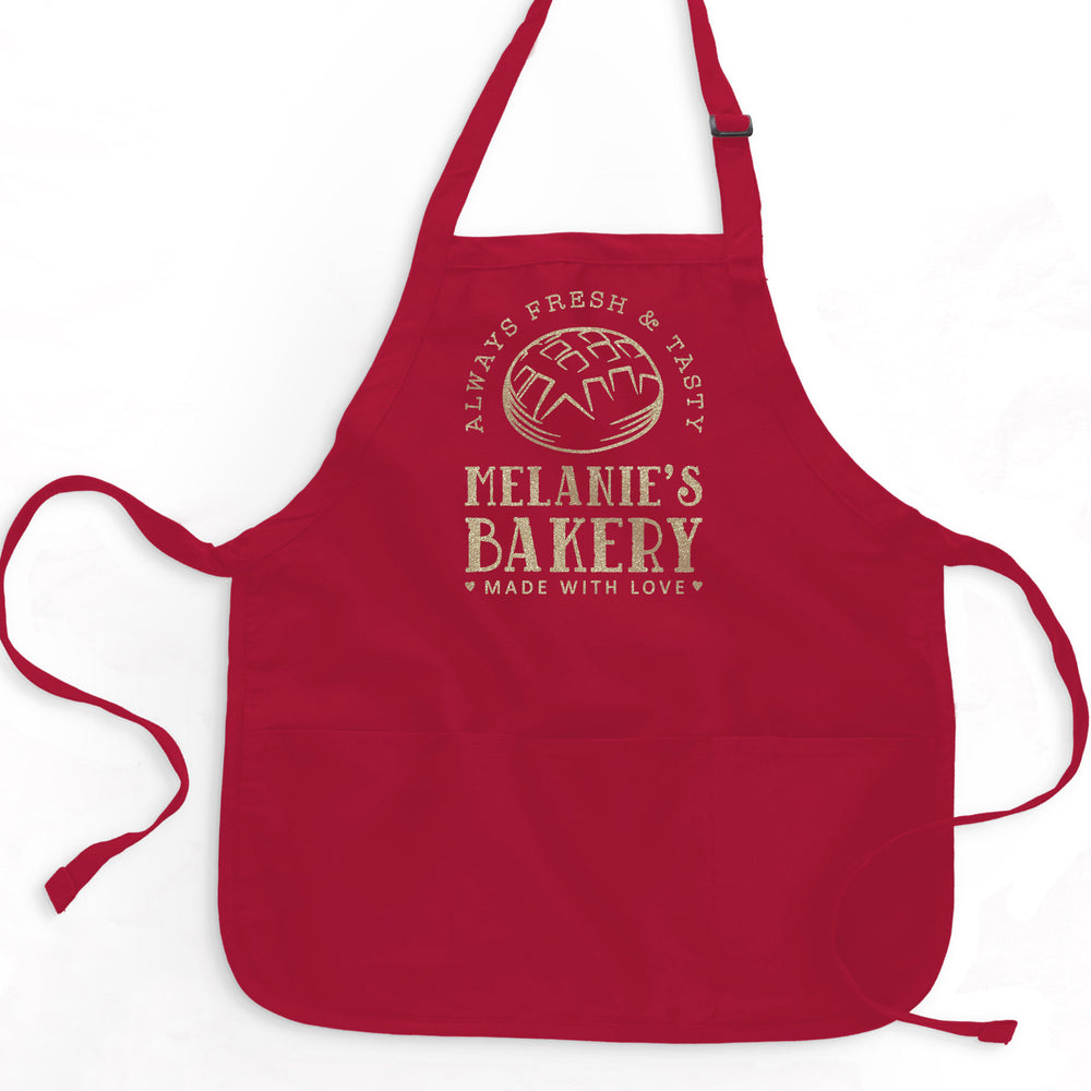 a short red apron printed with champagne glitter reading 