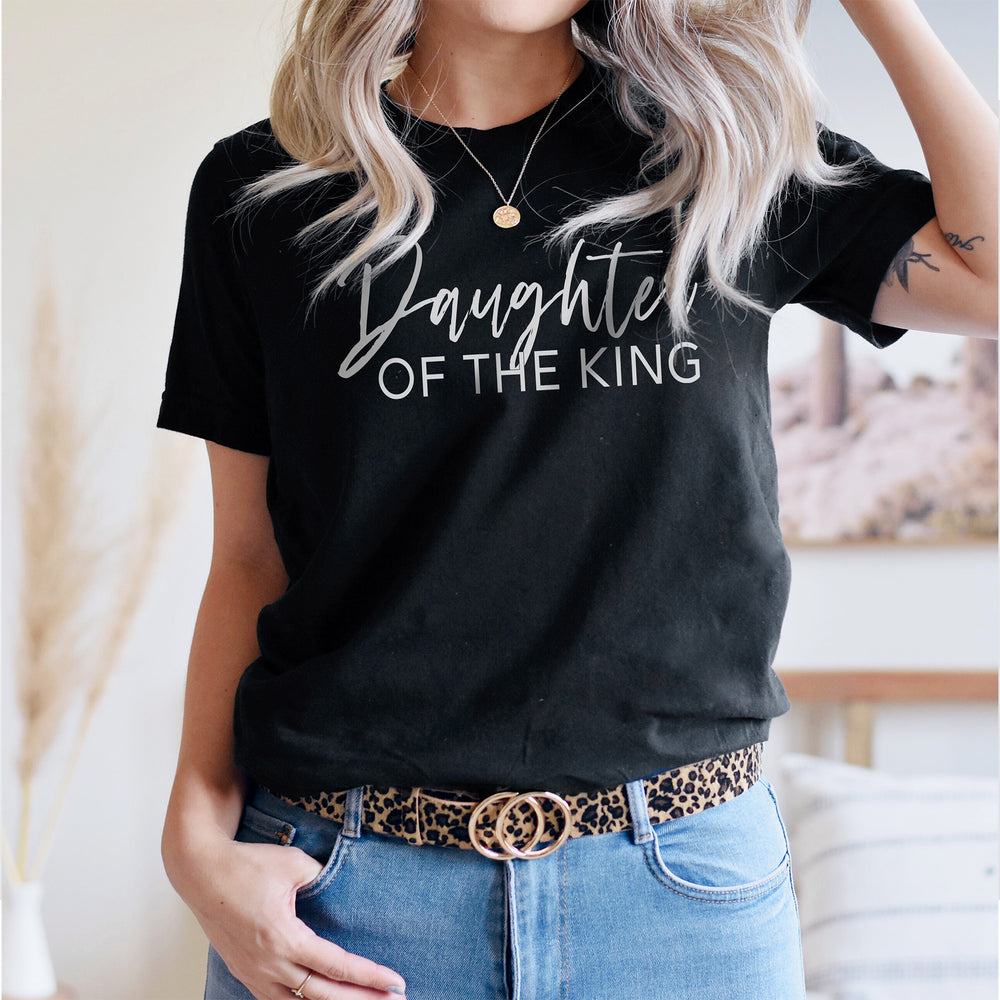 a young woman wearing a Daughter of the king shirt in black