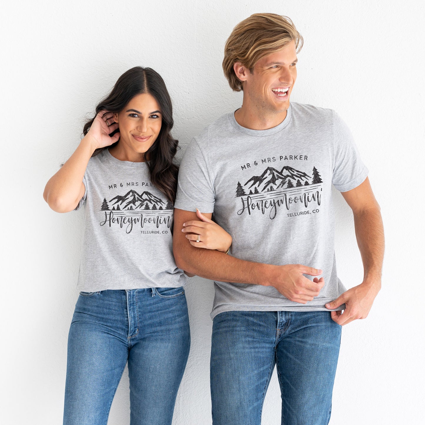 
                  
                    a happy young couple wearing customized mountain honeymoonin tees in grey
                  
                