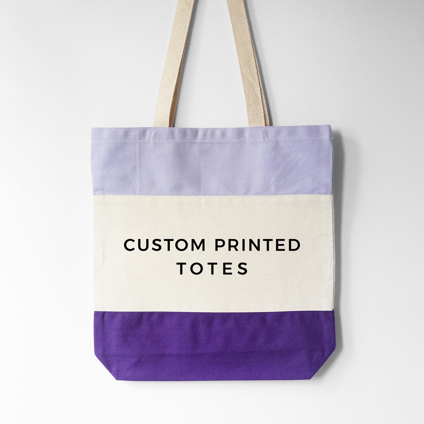 
                  
                    Design your own tri-color tote, shown in purple
                  
                