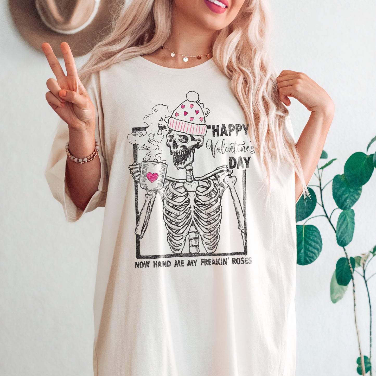 
                  
                    a pretty young woman wearing an oversized funny skeleton valentines day tee in natural
                  
                