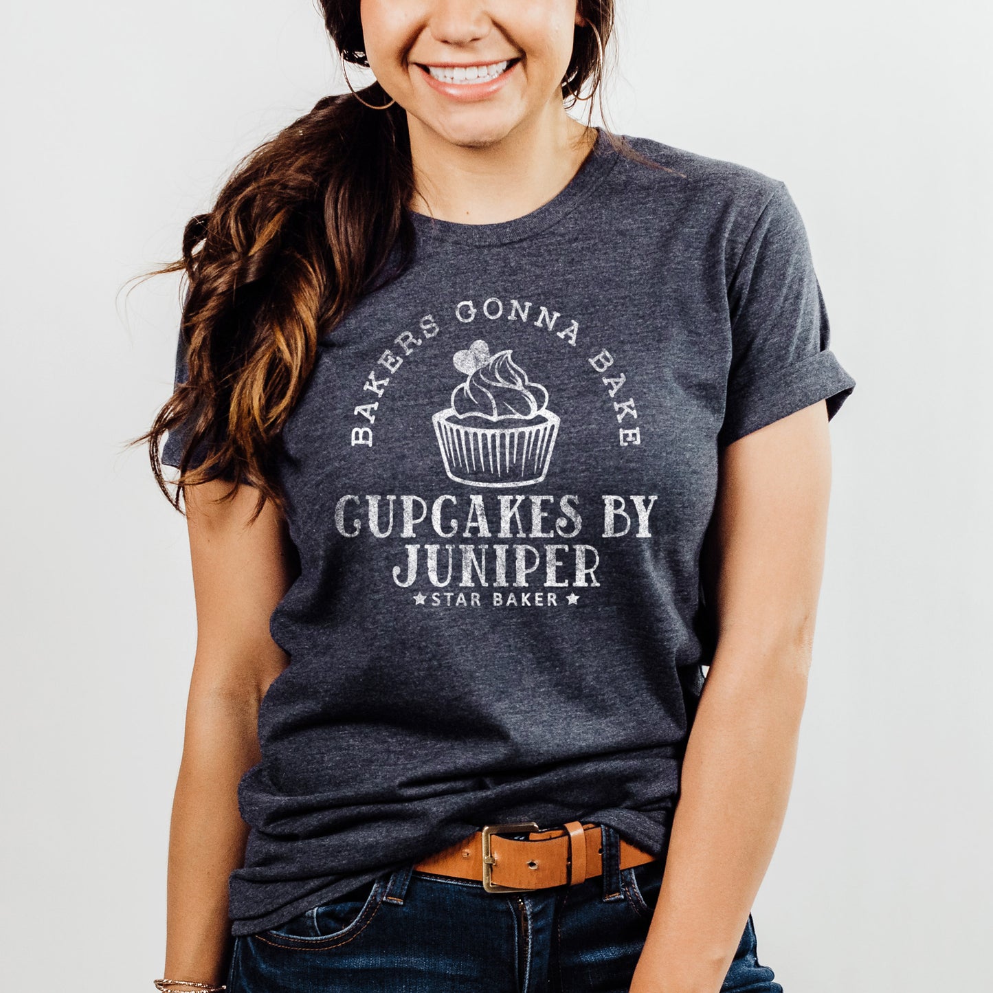 
                  
                    a young woman wearing a personalized a personalized cupcake baker shirt in navy
                  
                