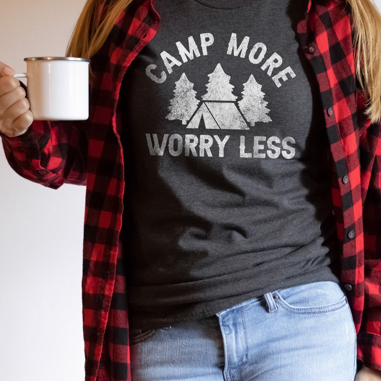 a young woman holding a coffee cup, wearing a camp more, worry less tee indark grey
