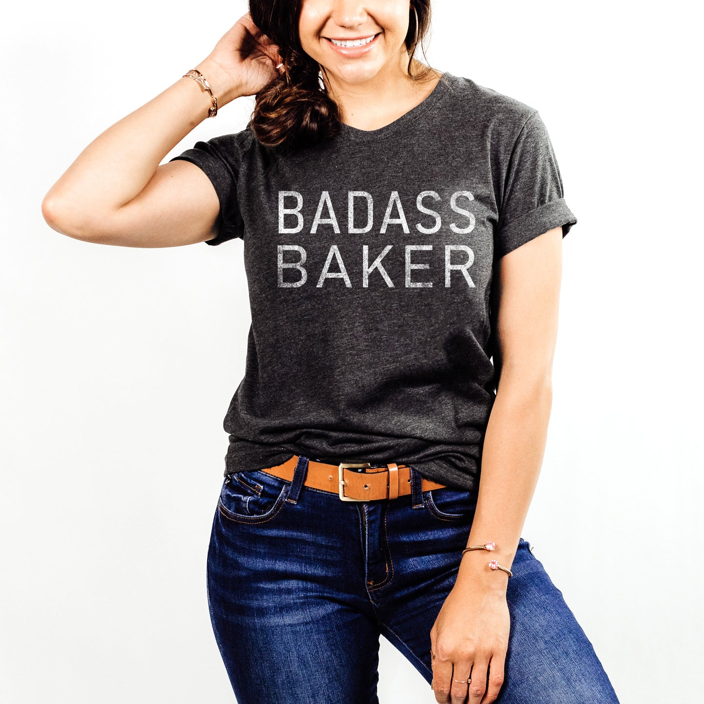 
                  
                    a smiling young woman wearing a badass baker shirt in dark grey
                  
                
