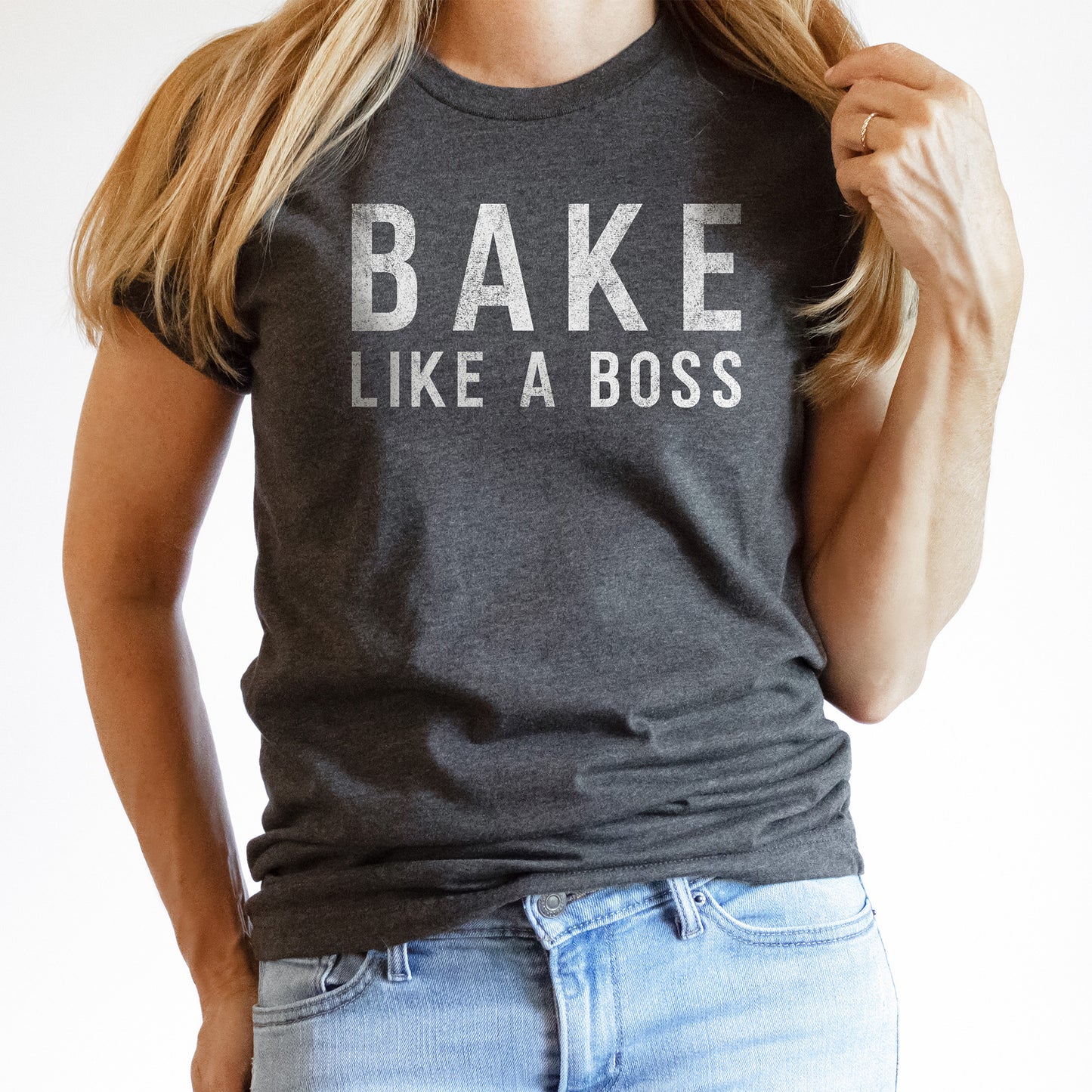 
                  
                    a young woman wearing a bake like a boss shirt in dark grey
                  
                