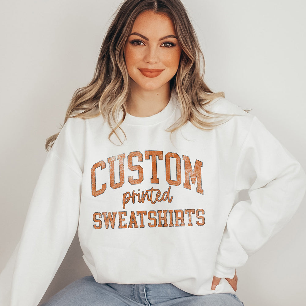 a pretty young woman wearing an oversized, custom printed crewneck sweatshirt in white