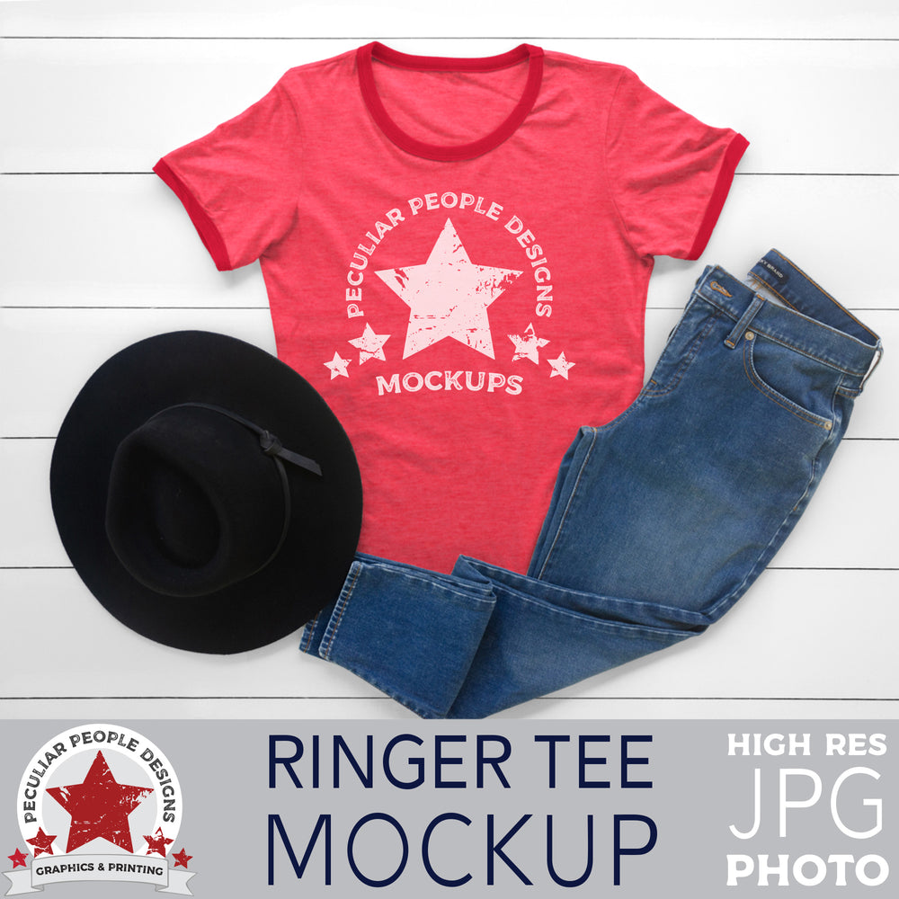 a mockup image of a red ringer tee, a black hat and blue jeans, layed out flat on a wood background