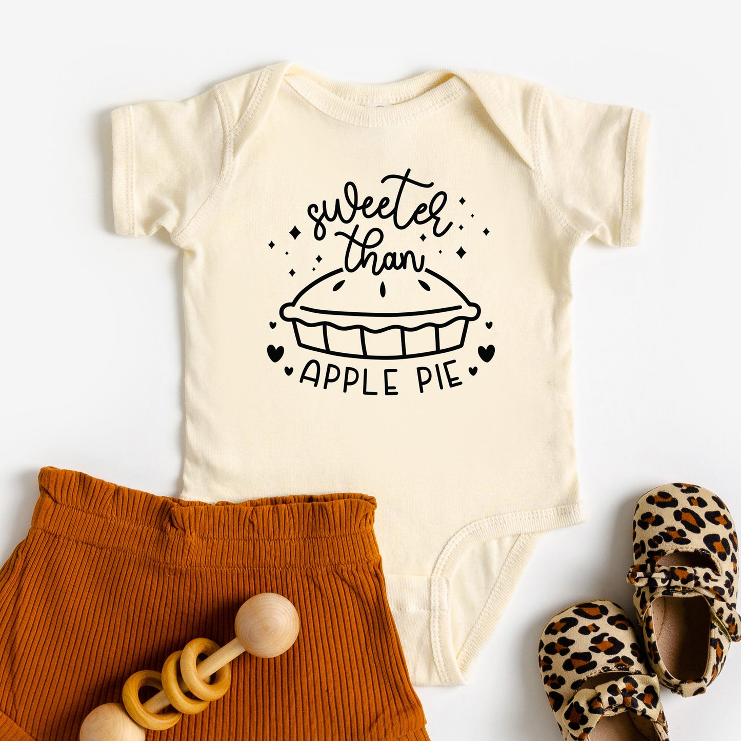 
                  
                    a sweeter than apple pie baby onesie in natural
                  
                