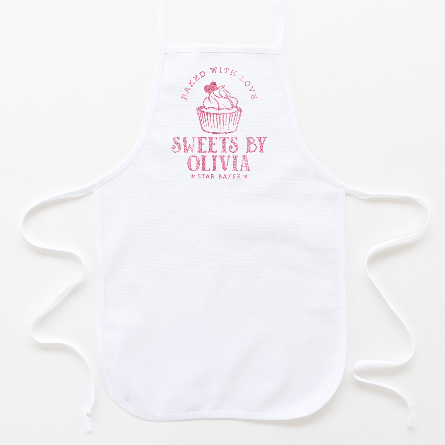 
                  
                    a kid's personalized cupcake baking apron in white
                  
                