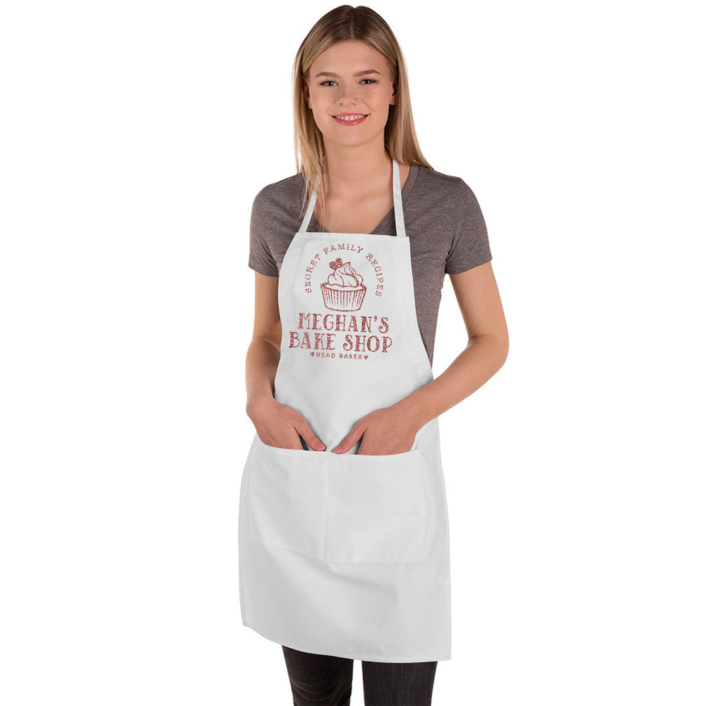 a young woman wearing a personalized cupcake baking apron in white butcher