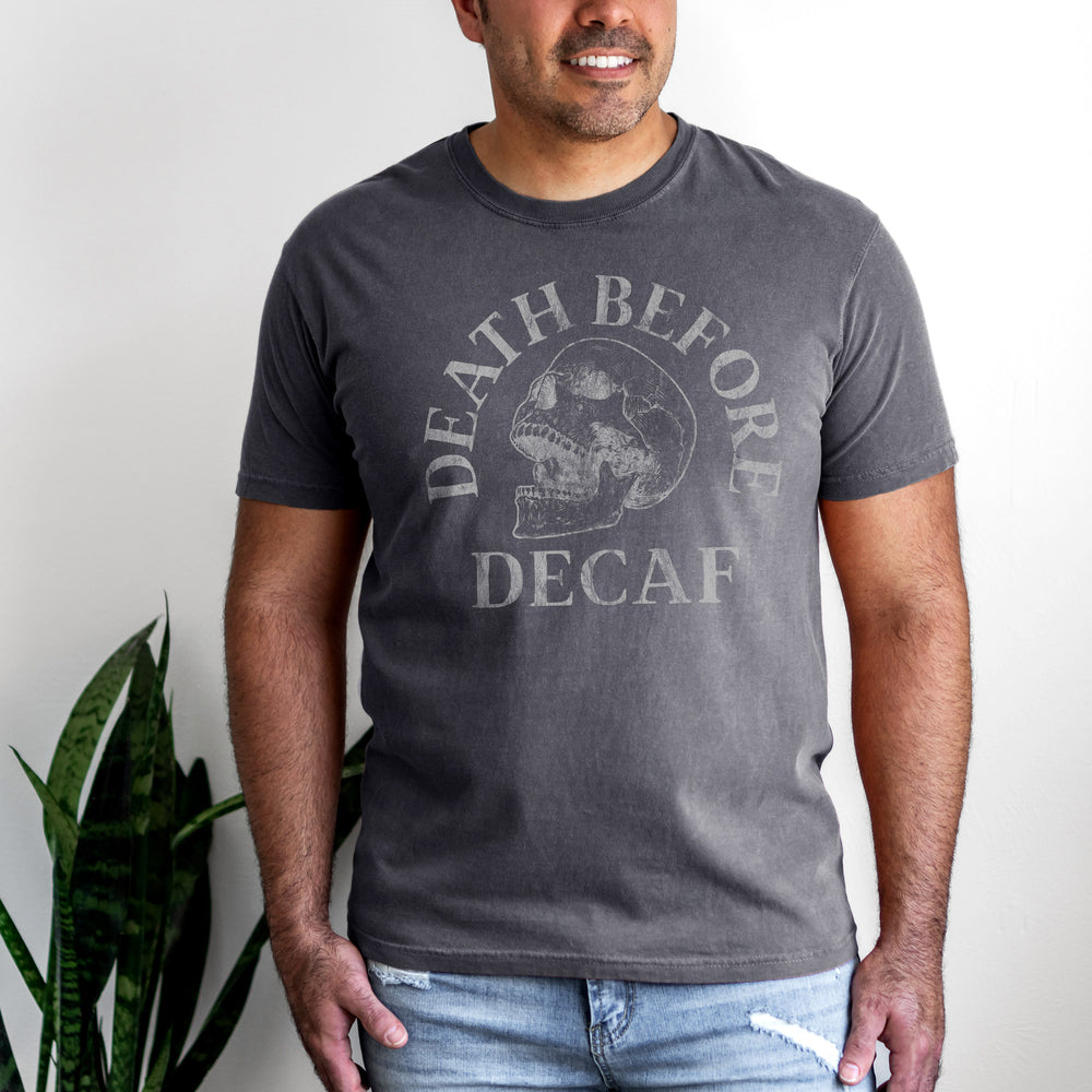a handsome man wearing a death before decaf shirt in pepper