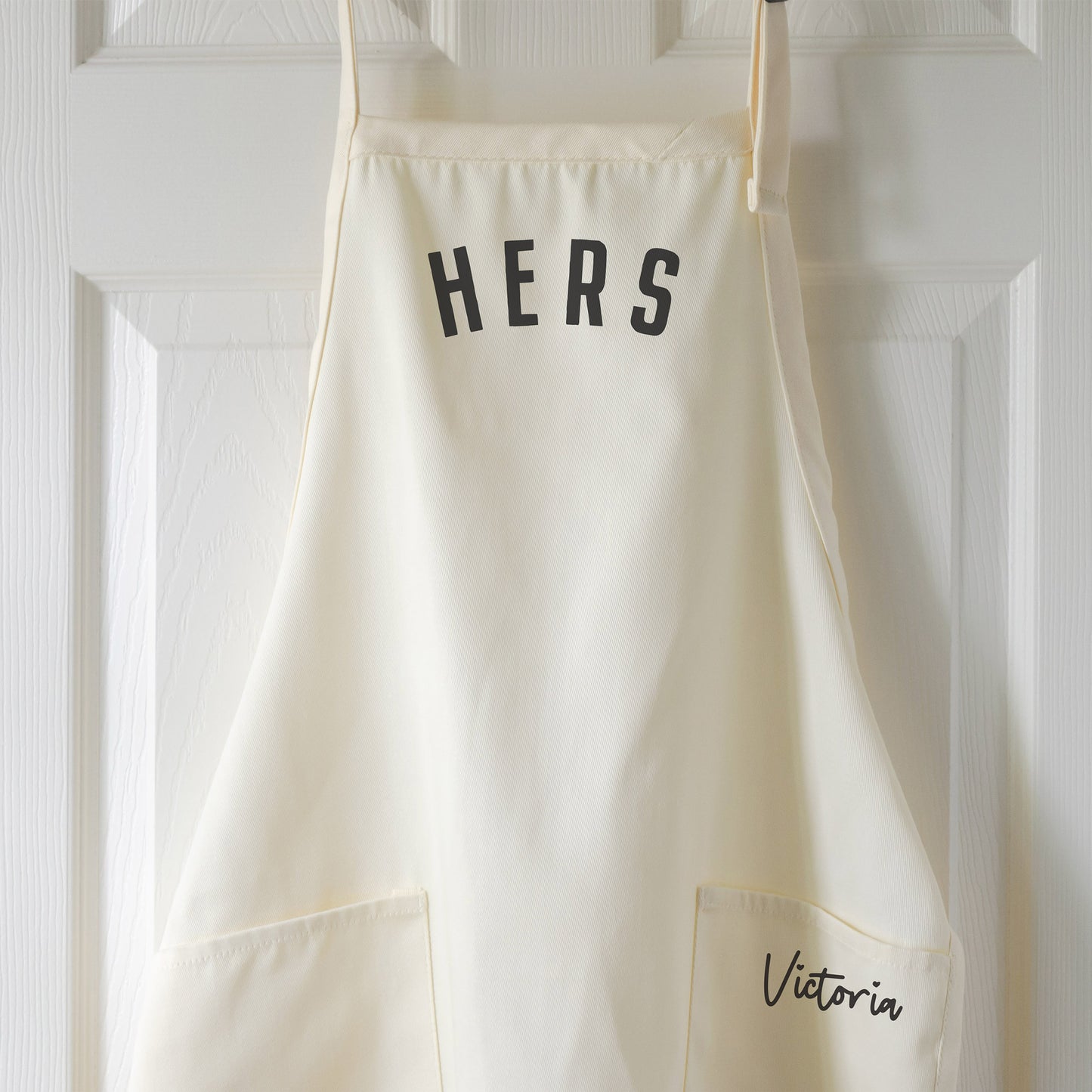 a personalized "hers" apron in natural