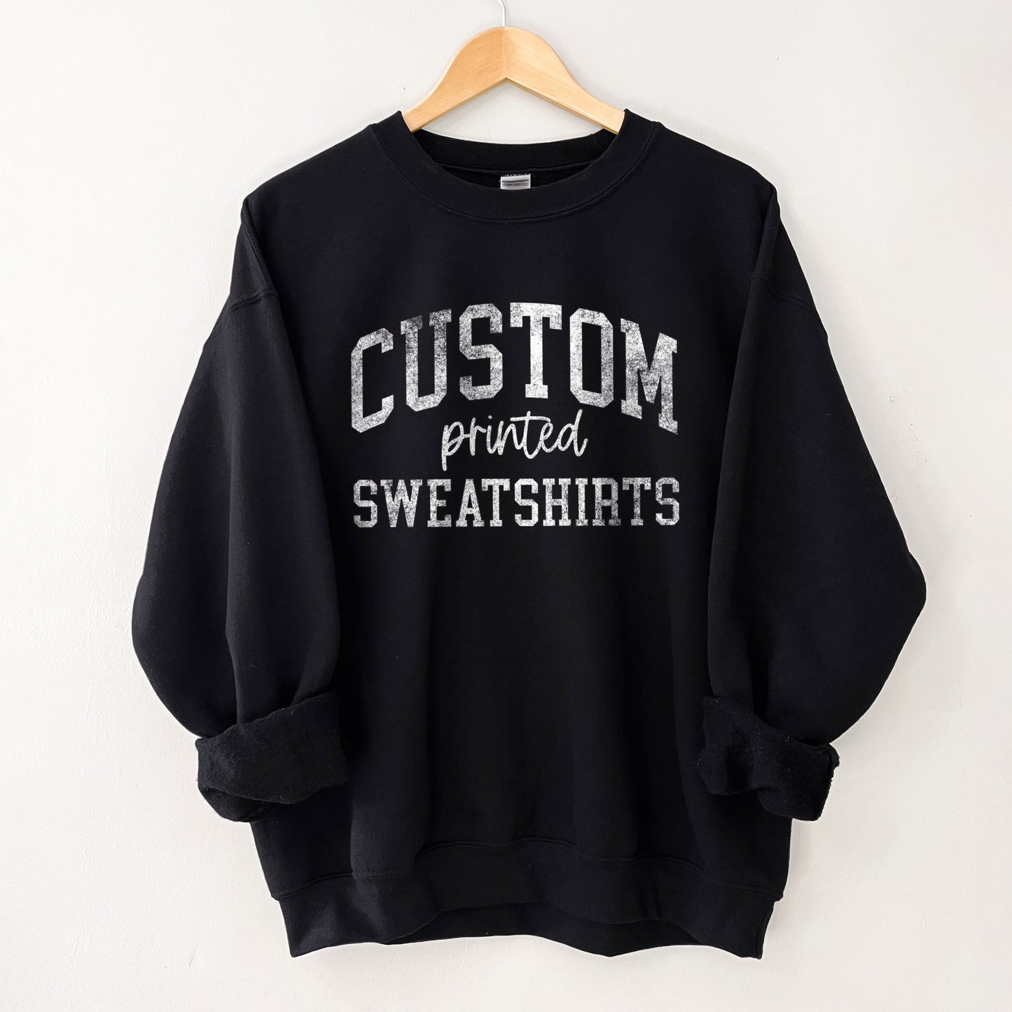 
                  
                    a black sweatshirt with text that reads "design your own sweatshirt"
                  
                