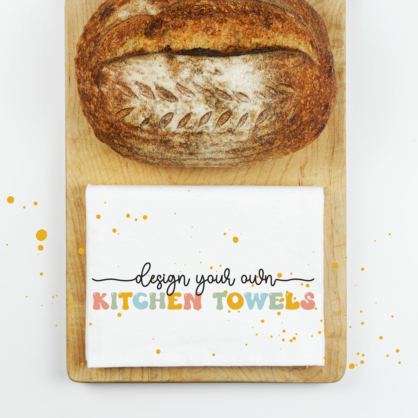 
                  
                    a folded kitchen towel on a cutting board with a loaf of bread
                  
                