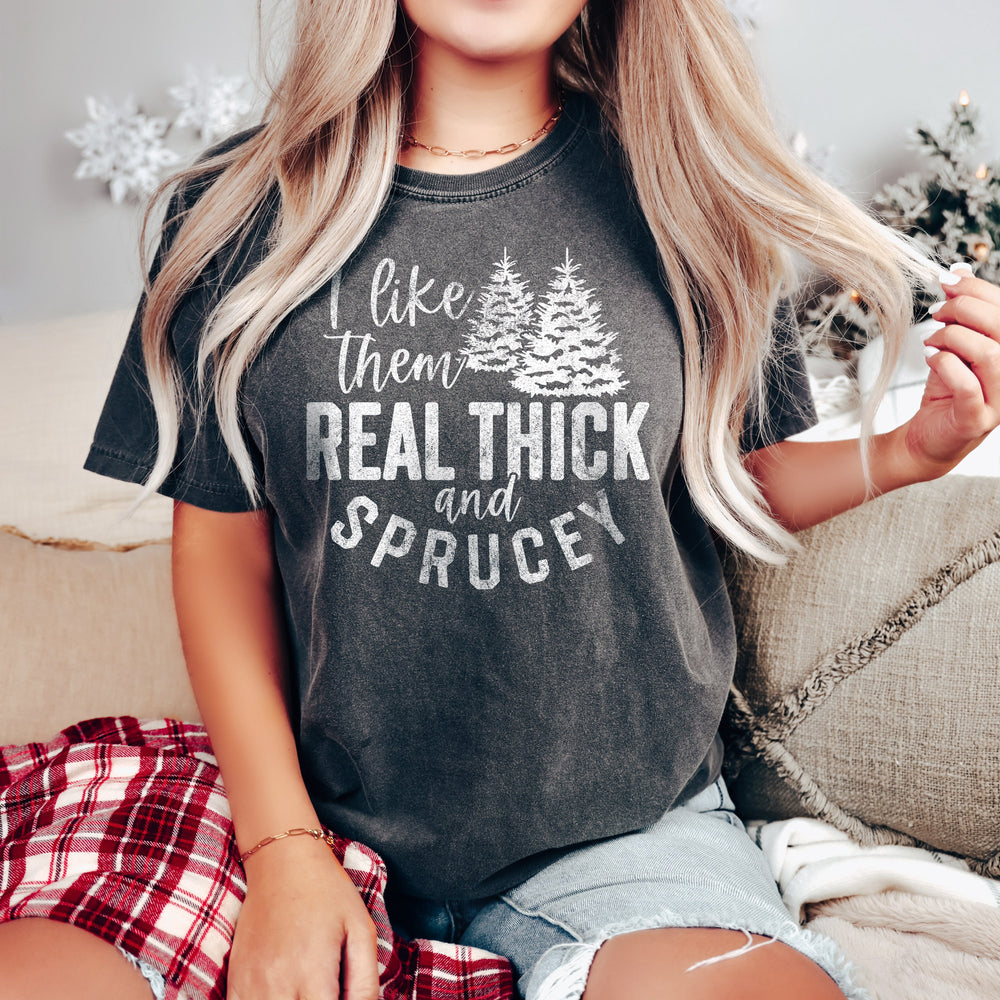
                  
                    a young woman in a christmas scene wearing a real thick and sprucey christmas tree shirt in pepper
                  
                