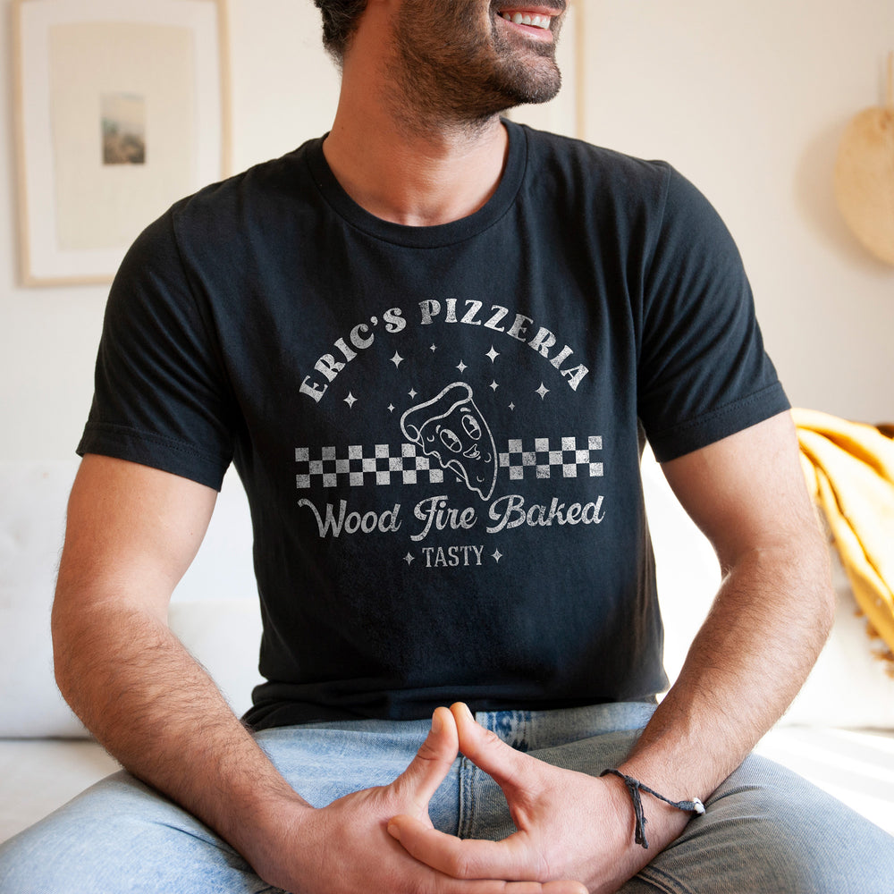 
                  
                    a handsome young man wearing a personalized retro pizza shirt in black
                  
                