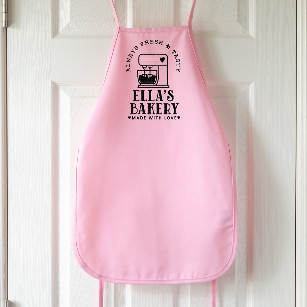 
                  
                    a kids personalized baking apron in pink pastel
                  
                