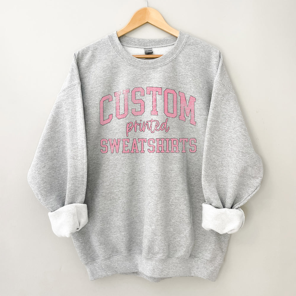 a sport grey sweatshirt with text that reads "design your own sweatshirt"