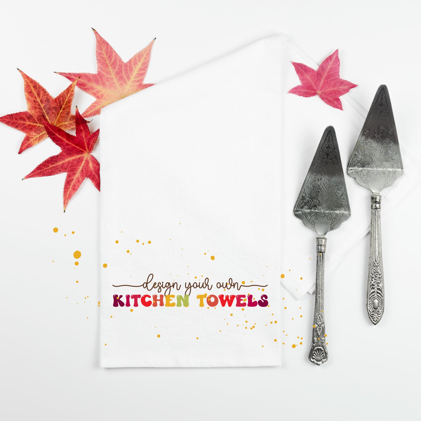 
                  
                    a kitchen towel part way unfolded with fall leaves and pie servers
                  
                