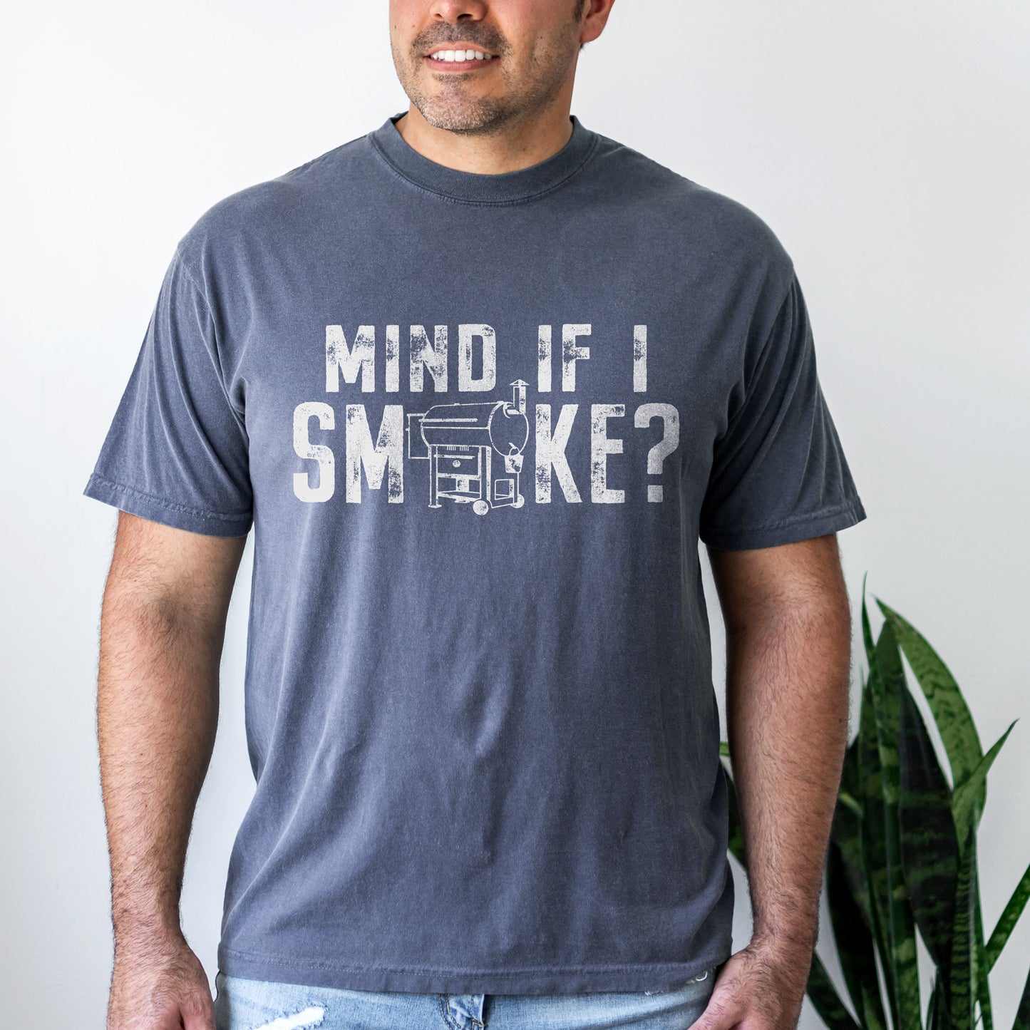 a handsome man wearing a Mind If I Smoke? t-shirt in denim