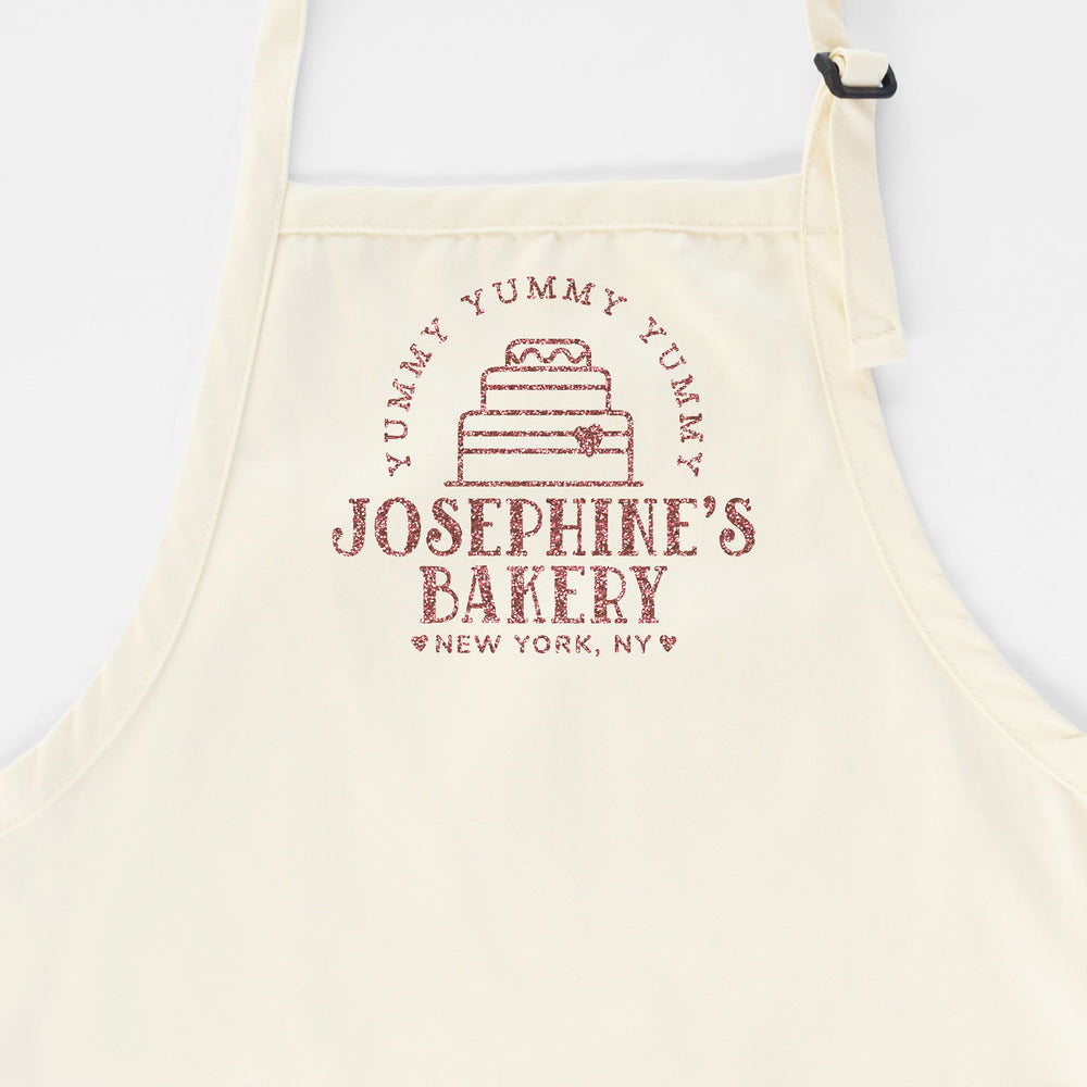 A personalized cake baking apron in natural