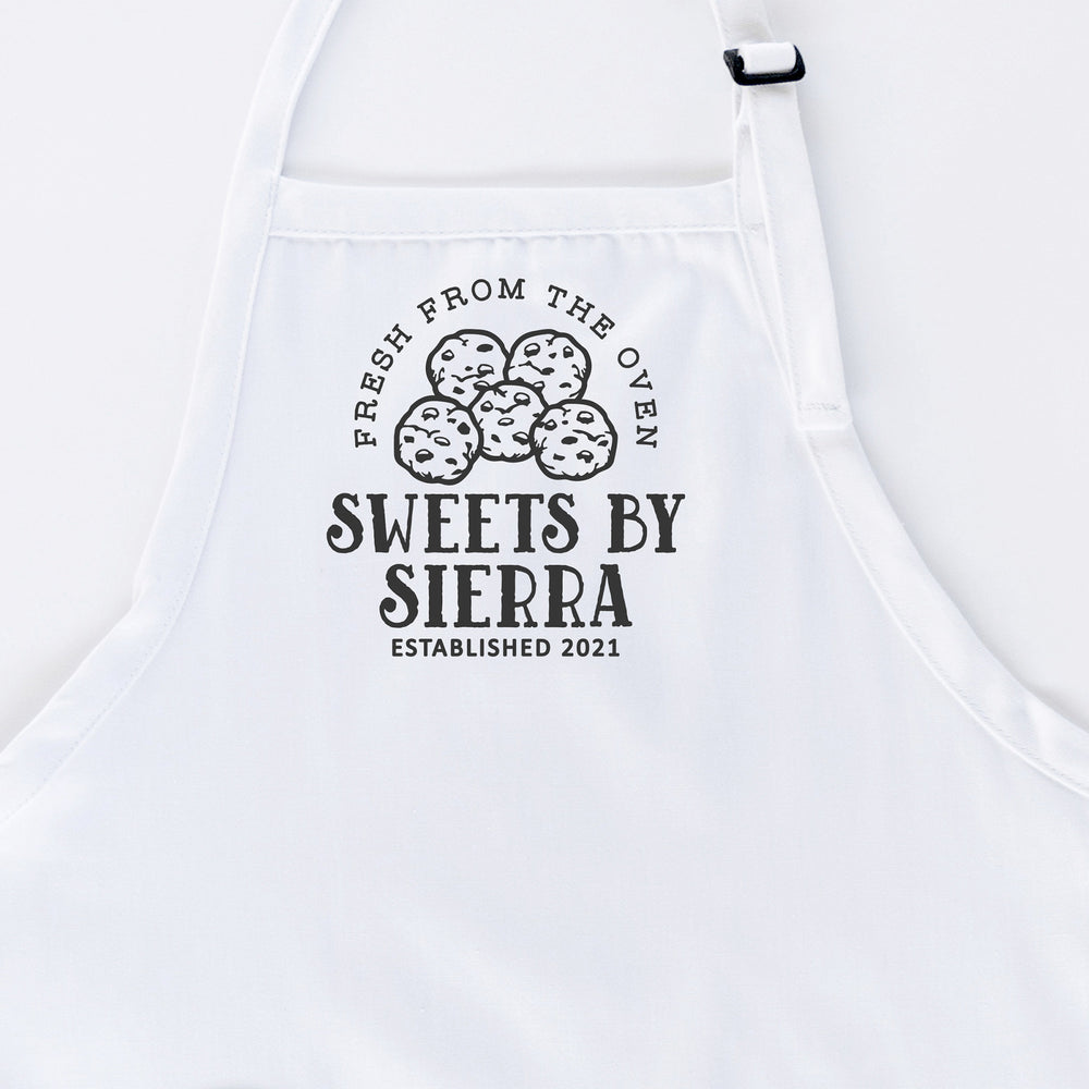 
                  
                    a personalized cookie baking apron in white
                  
                