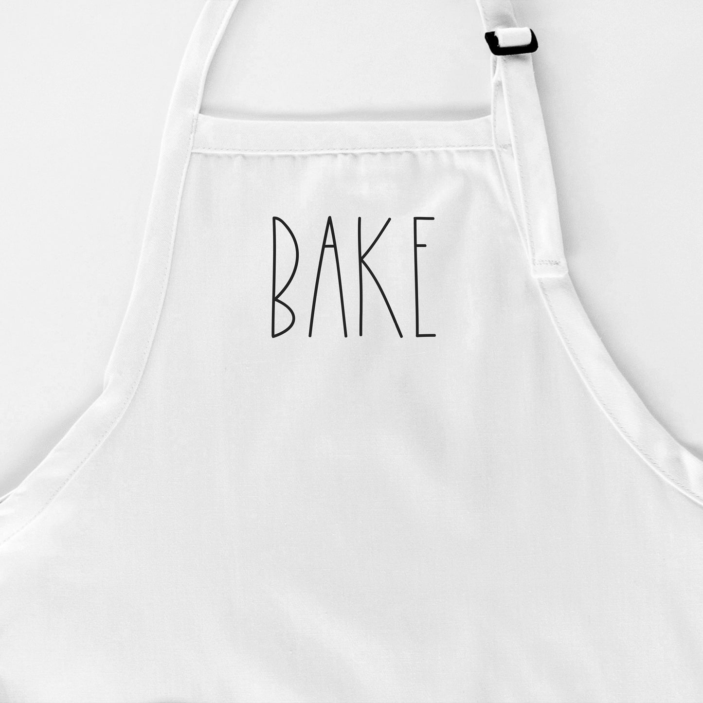 
                  
                    a Bake apron in white
                  
                