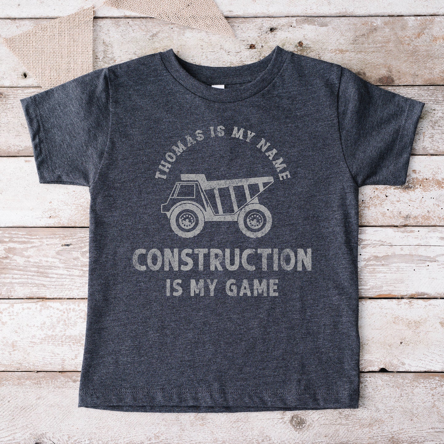 
                  
                    a kid's dump truck construction co. shirt in dark grey
                  
                