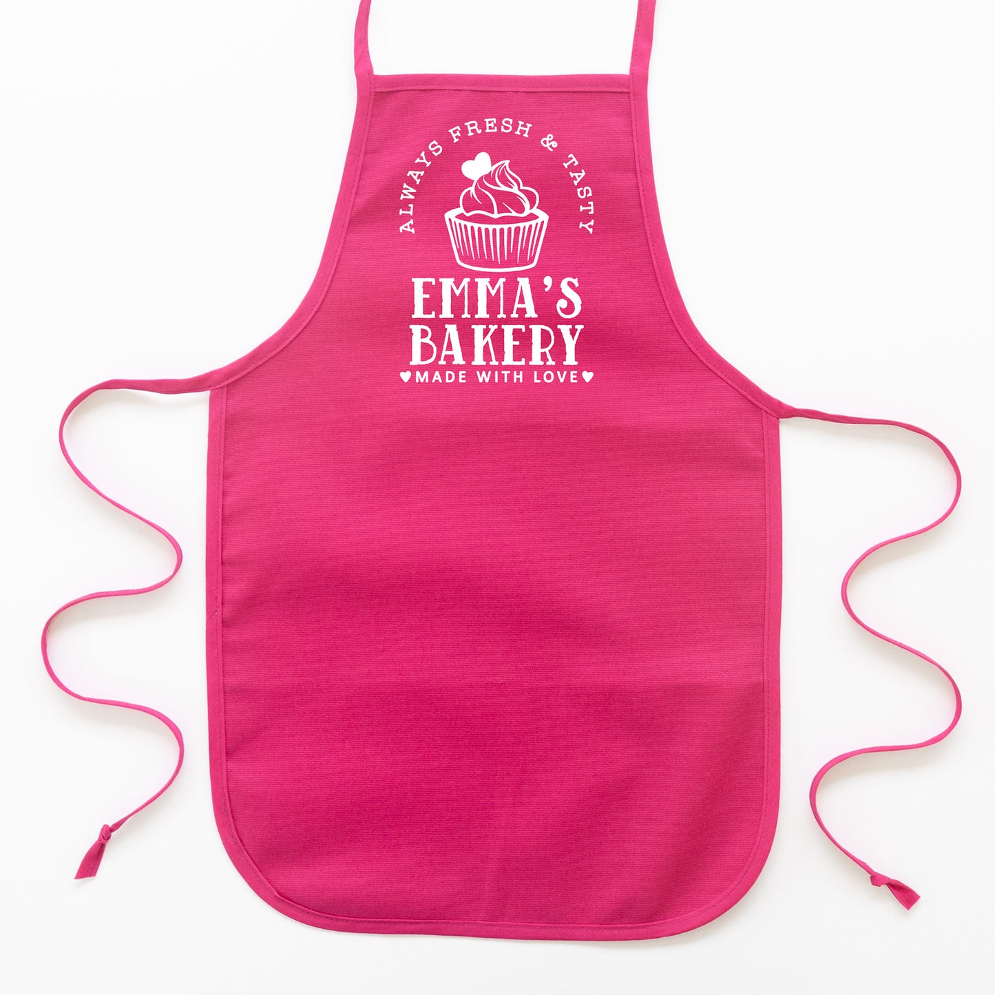 a kid's personalized cupcake baking apron in hot pink